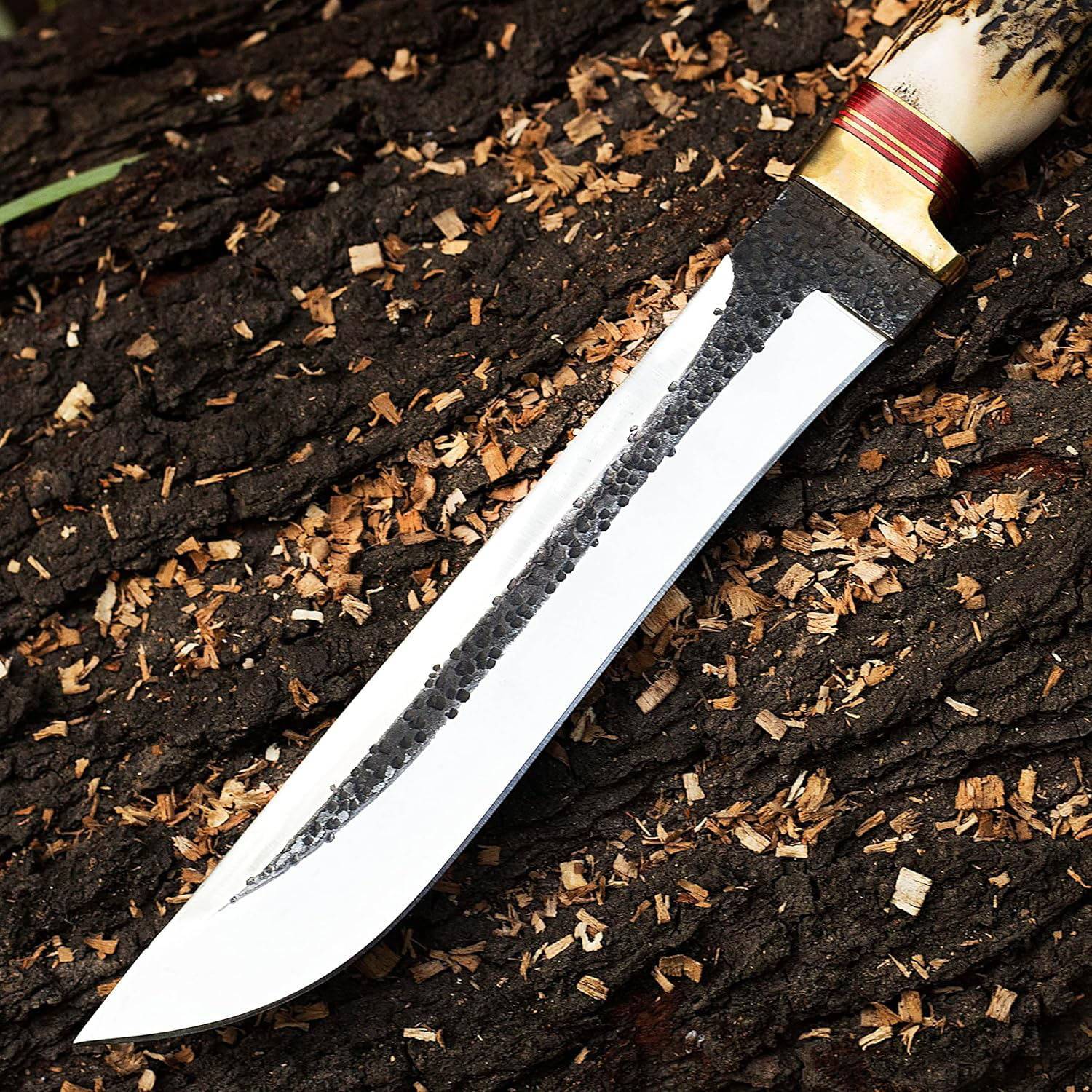 Custom Forged Bowie Knife with 12-inch hand-forged 1095 high carbon steel blade, natural hammer marks, mirror polished, stag antler handle, and cowhide leather sheath, perfect for hunting and skinning.