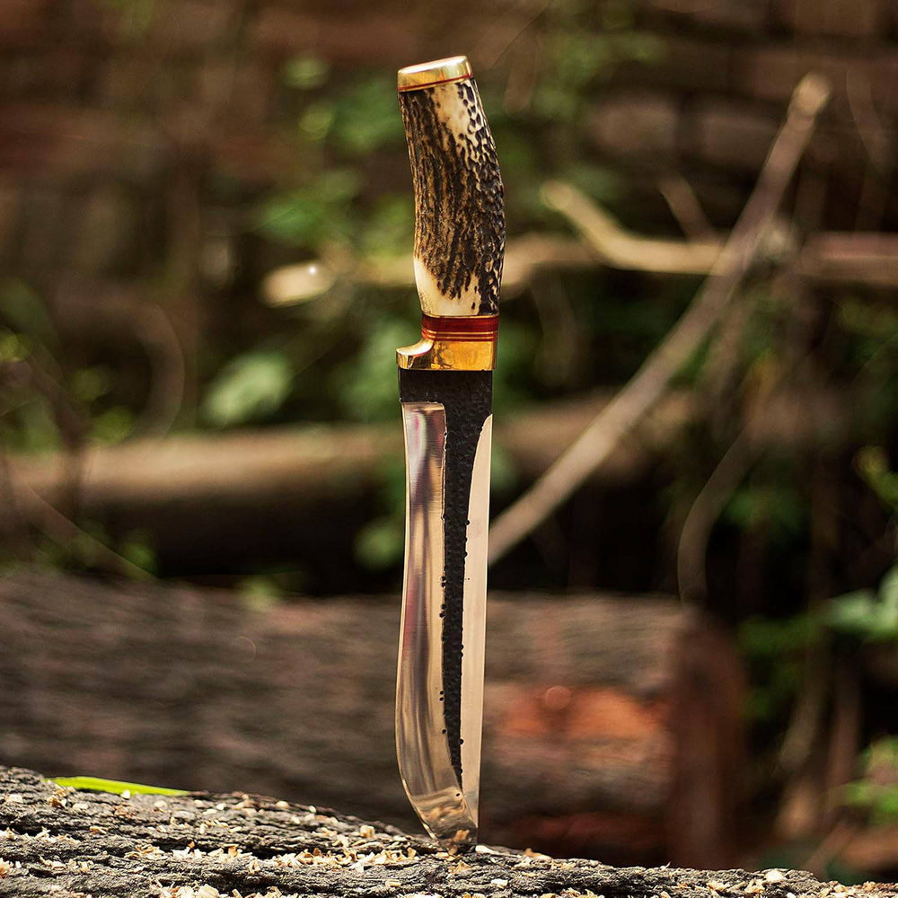 Custom forged Bowie knife with mirror-polished, 1095 high carbon steel blade and natural hammer marks. Stag antler handle and cowhide leather sheath. Overall length 12 inches.