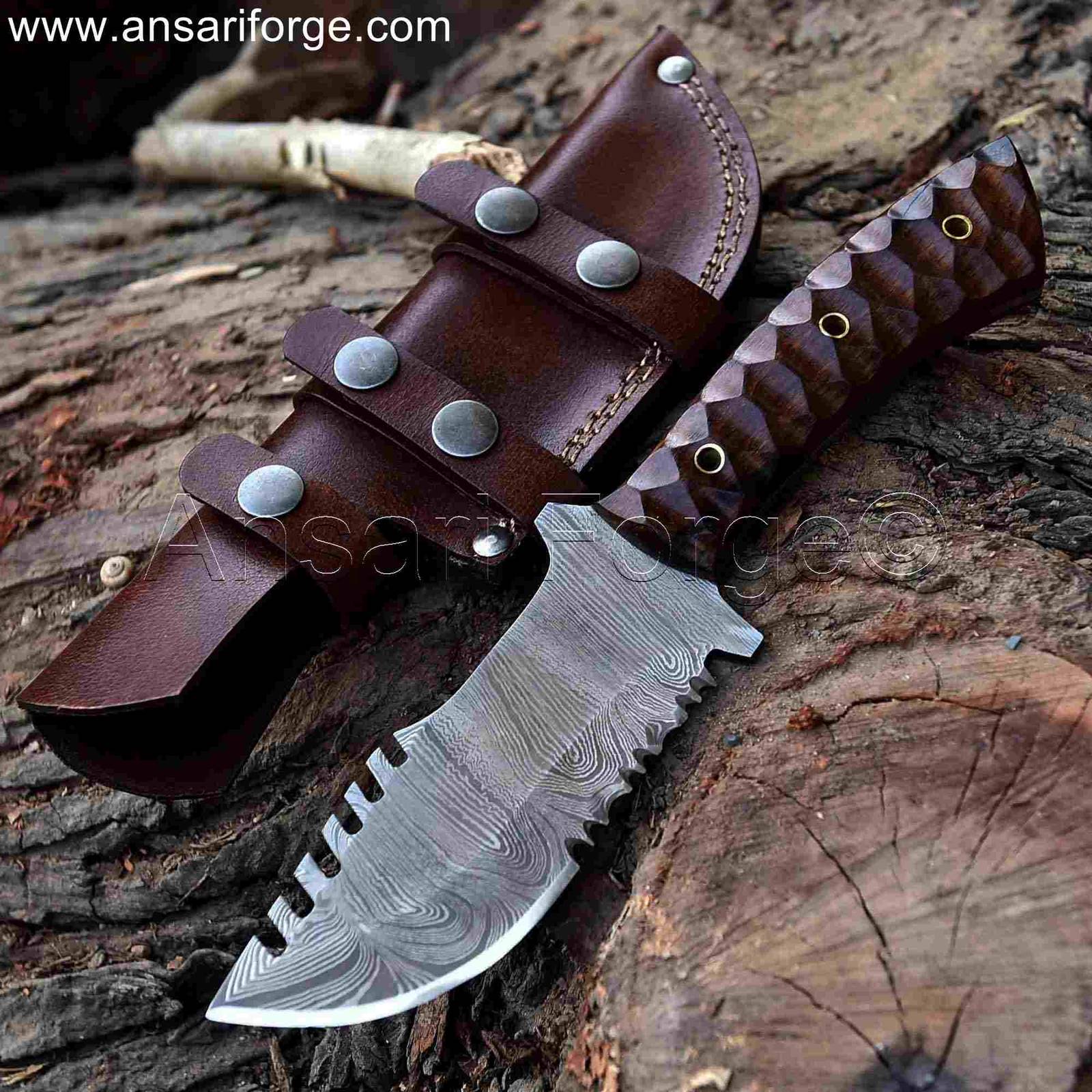 The Camper Damascus Tracker Knife, a hand-forged fixed blade knife with a walnut wood handle and a cowhide leather sheath.