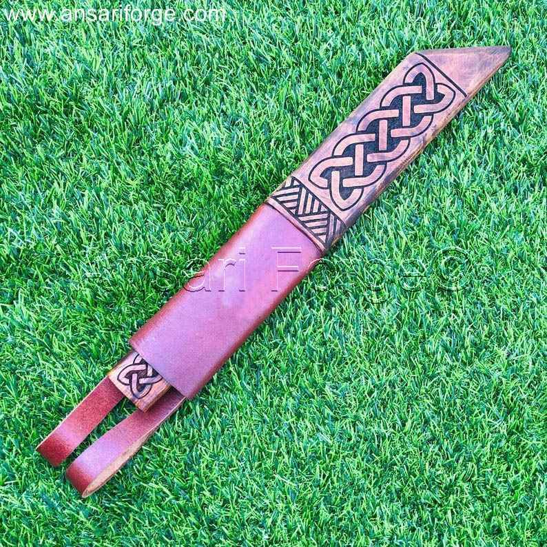 A close-up of the Beagnoth's sheath, featuring the dragon carving and the rosewood inlay.
