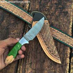 Damascus cowboy belt knife in hand.