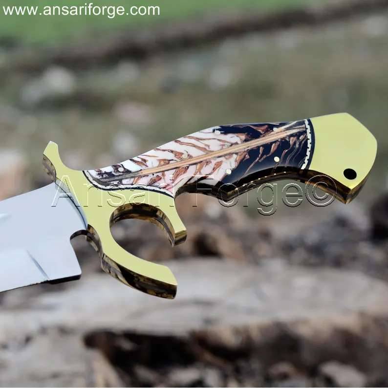 Detailed view of the pine cone resin epoxy handle and brass hilt of a Custom Bowie Knife.