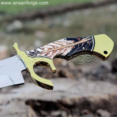 Detailed view of the pine cone resin epoxy handle and brass hilt of a Custom Bowie Knife.
