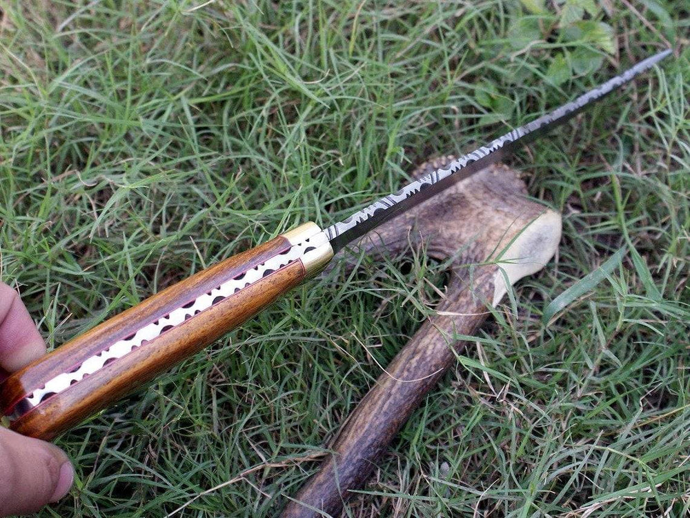 Custom Damascus steel Hunting Bowie knife with a clip point blade, highlighting the full tang construction and elegant rosewood handle.