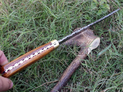 Custom Damascus steel Hunting Bowie knife with a clip point blade, highlighting the full tang construction and elegant rosewood handle.
