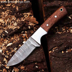 Hephaestus Damascus Steel Hunting Knife Held Against Natural Background, Highlighting Beautiful Patterns