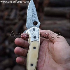 Hand holding the Custom Damascus Folding Pocket Knife open, showcasing its comfortable grip and use in a everyday task