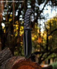 Black Cinder Hunting Knife alongside other outdoor gear, like a campfire or backpack, creating a sense of adventure and versatility.