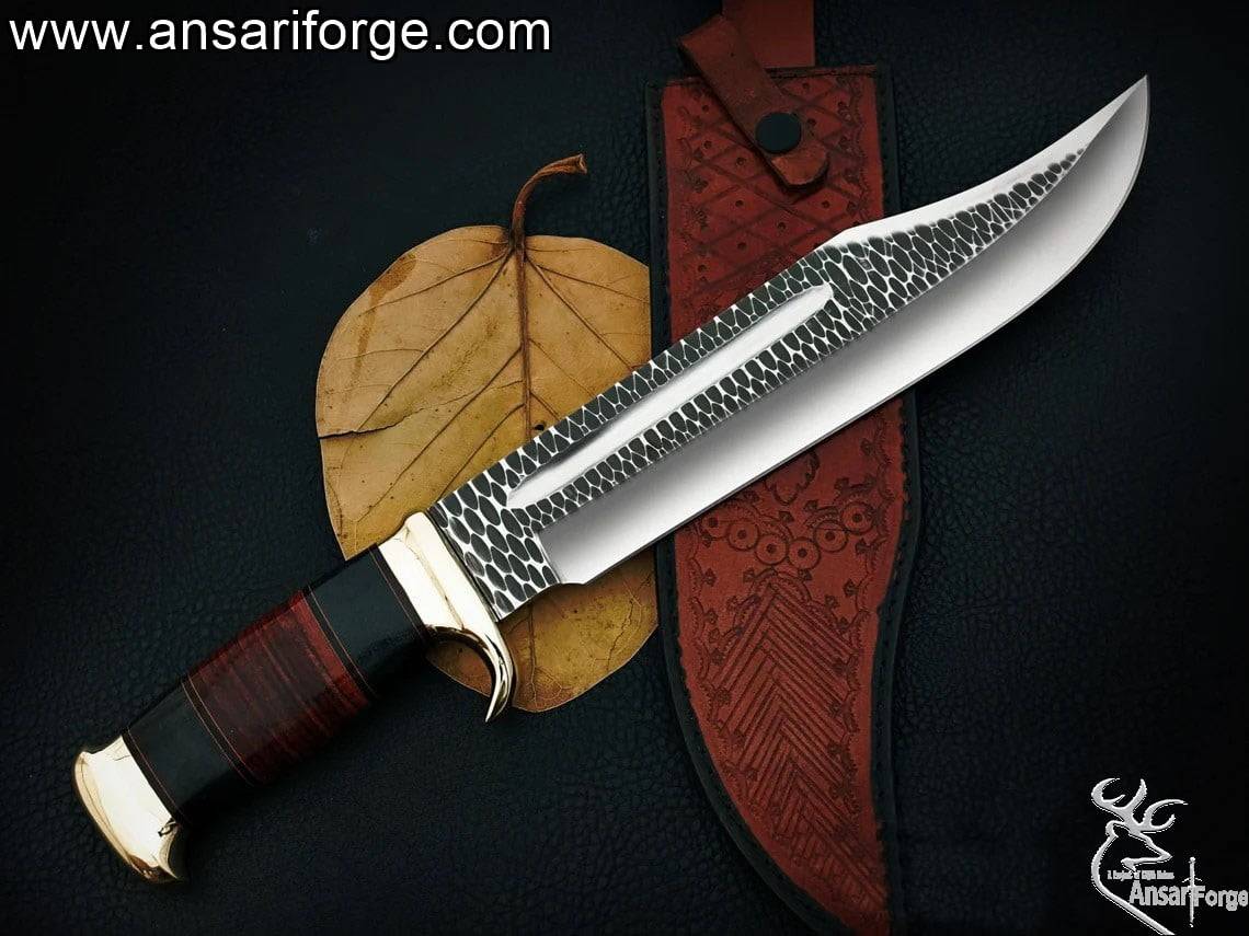 custom-made Crocodile Dundee Bowie Knife. D2 steel blade with hammer forge marks, brass hilt and pommel, and a leather and buffalo horn handle.