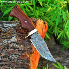 Close-up of a Handmade, forged Damascus Knife blade, showcasing the intricate feather pattern.