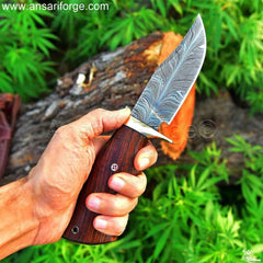 A custom made Feather Damascus Hunting Knife, ready for your next outdoor adventure.