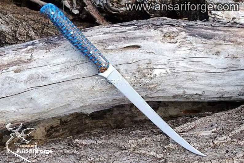 A close-up of a sharp fillet knife blade, showcasing its intricate details and high-quality craftsmanship.
