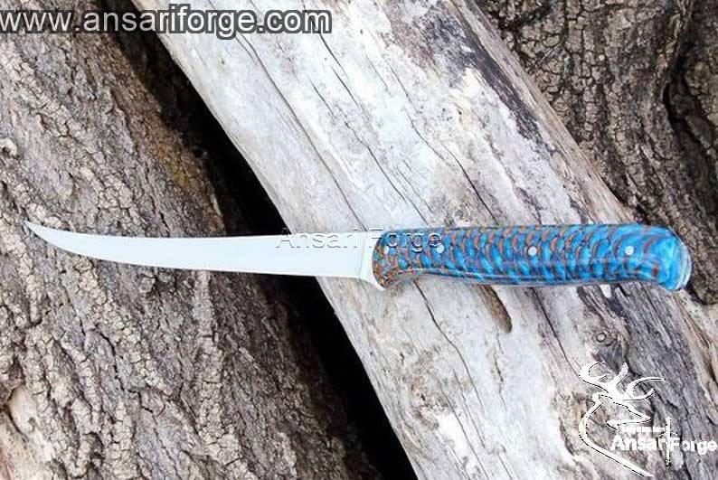A sharp fillet knife with a D2 tool steel blade and a stabilized pine cone handle.
