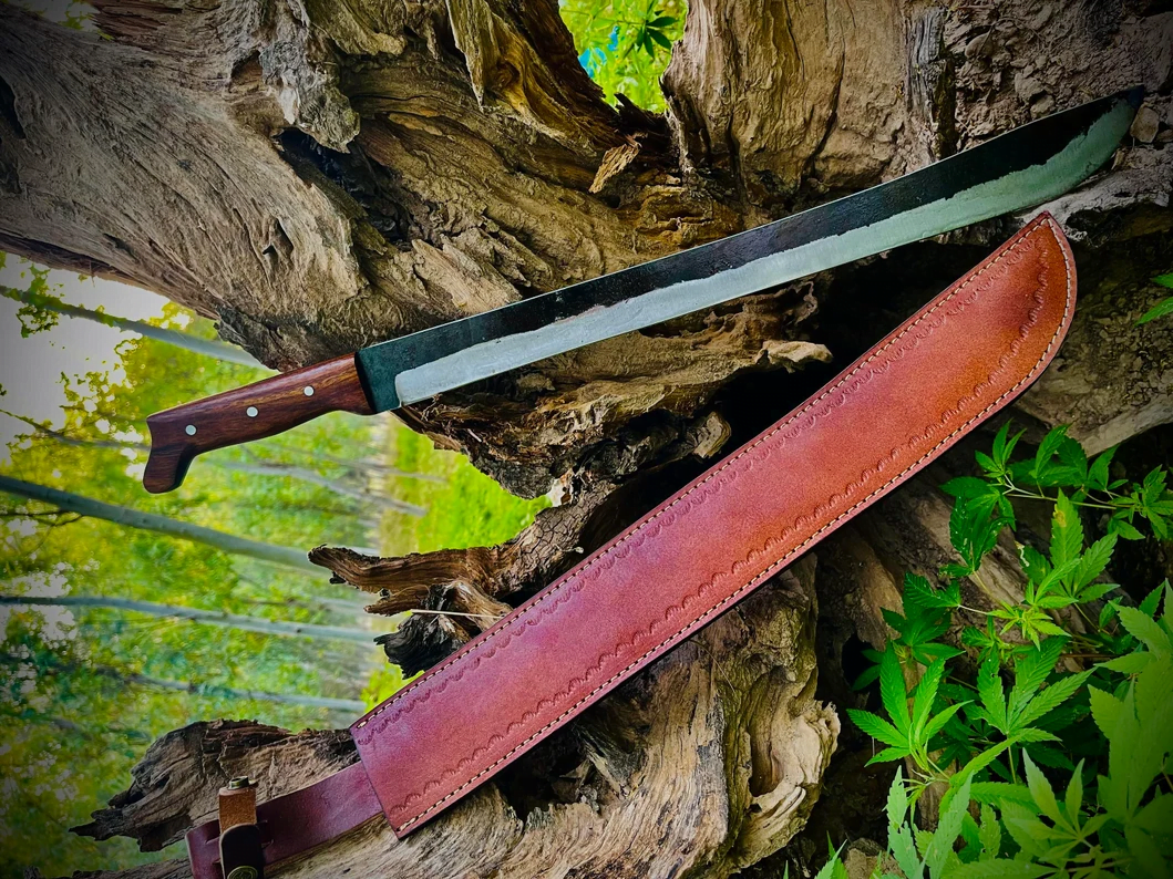 Hand-forged 1095 high carbon steel machete knife with rosewood handle and leather sheath.