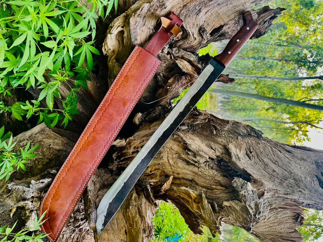 Hand-forged 1095 high carbon steel machete knife with rosewood handle and leather sheath.