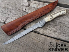Handmade Damascus fillet knife with twist pattern steel blade and stag antler handle.