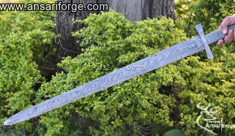 Precision ground edge and 5mm thick spine of the functional Damascus steel sword.