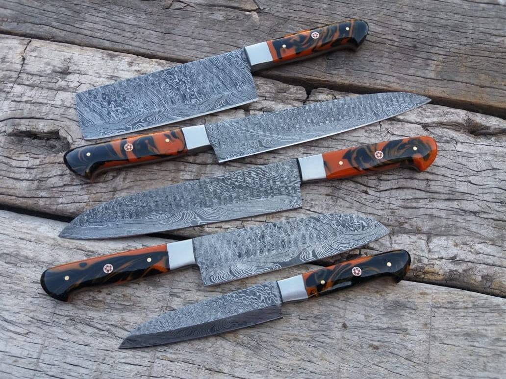 Artisan-crafted Damascus kitchen knives, ready for use.