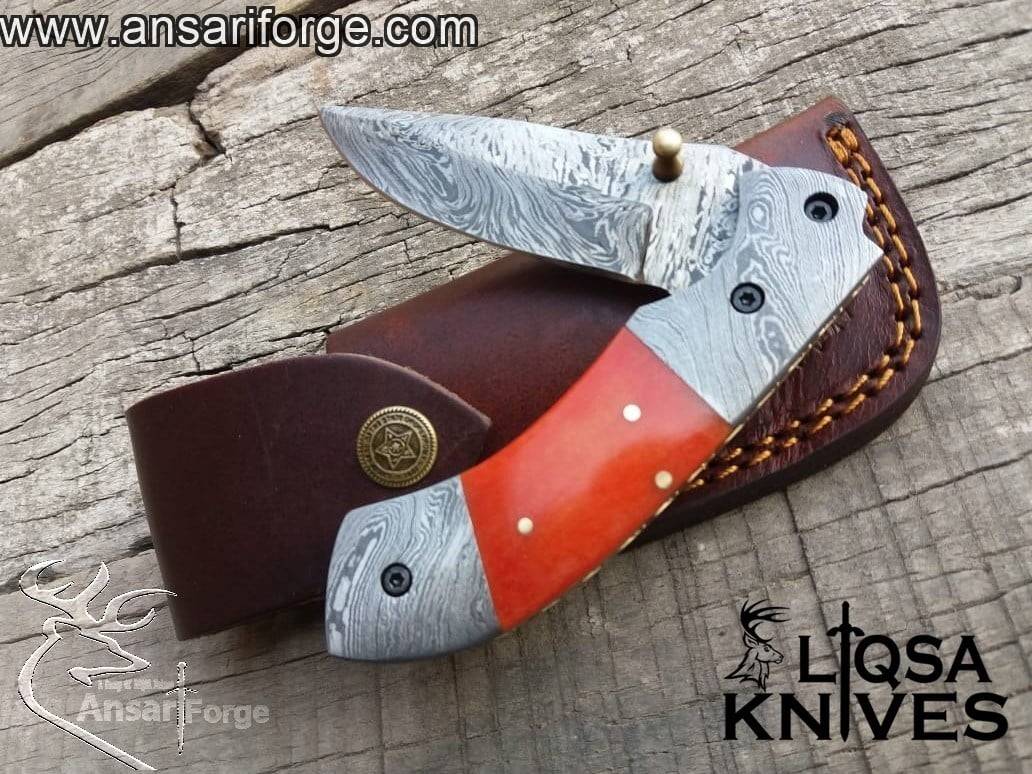 Camel bone dyed handle of the Folding Utility Knife, featuring a comfortable grip and elegant brass frame with file work.