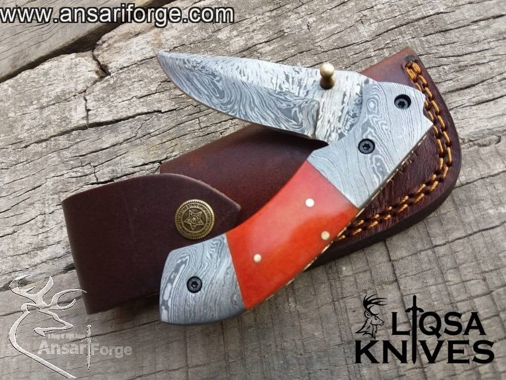 Camel bone dyed handle of the Folding Utility Knife, featuring a comfortable grip and elegant brass frame with file work.