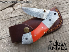 Camel bone dyed handle of the Folding Utility Knife, featuring a comfortable grip and elegant brass frame with file work.