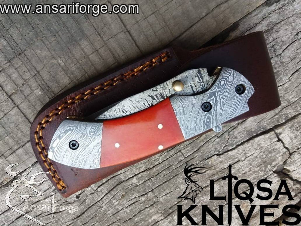 Close-up view of the drop point blade on the Damascus Folding Knife, highlighting the intricate 580-layer Damascus steel design.