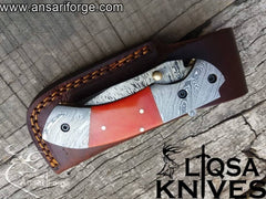Close-up view of the drop point blade on the Damascus Folding Knife, highlighting the intricate 580-layer Damascus steel design.