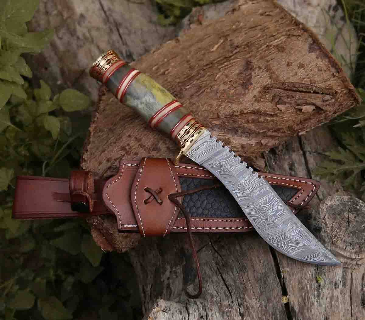 Razor's Edge damascus steel hunting knife held in hand, showing comfortable bone handle