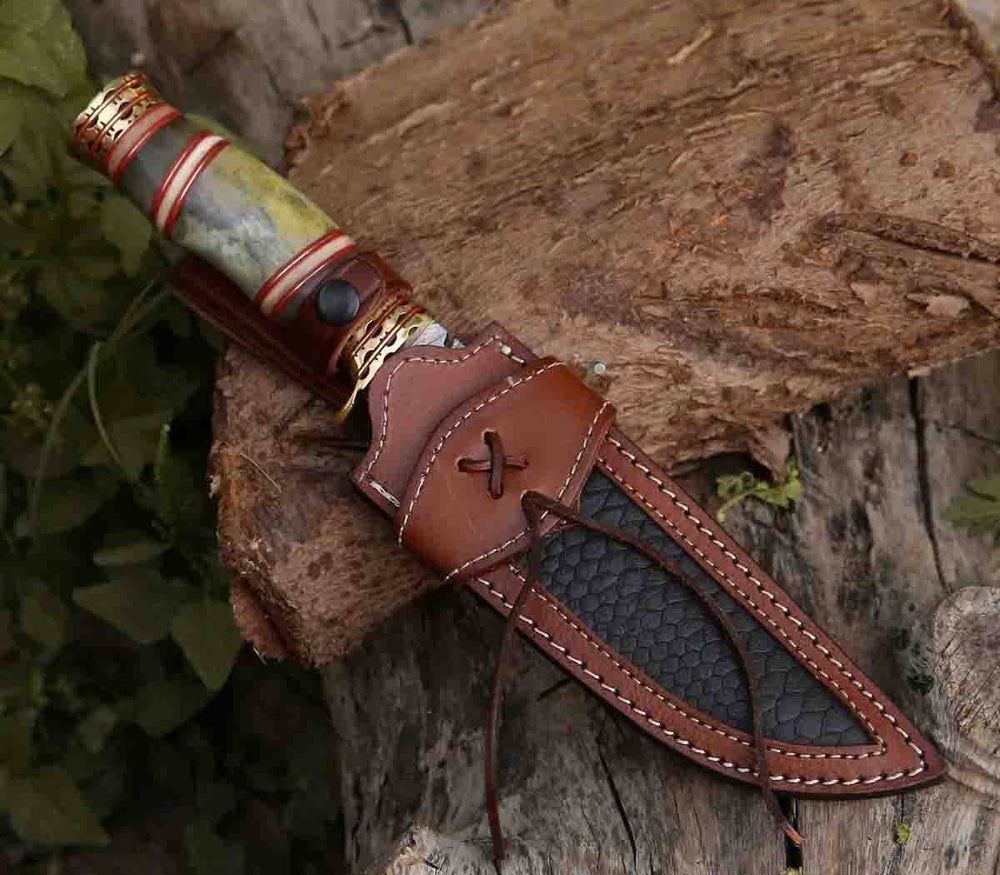Razor's Edge 13-inch damascus steel hunting knife lying on a wooden surface, suitable for camping or hunting.