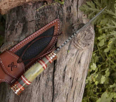 The "Razor's Edge" knife in its entirety, with the bone handle, brass hilt, and leather sheath visible.