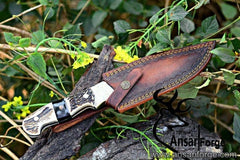 Fixed blade hunting knife with D2 steel blade, stag handle and brown leather sheath.