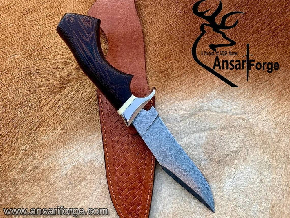 Hand forged Damascus knife with patterned steel blade, dark wood handle, and leather sheath - Ansari Forge custom outdoor tool for hunting and survival.